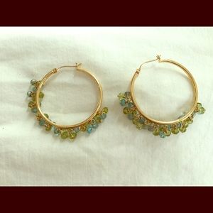 Gold hoop earring with blue and green topaz